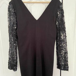 Mini, open back black dress with details on sleeves